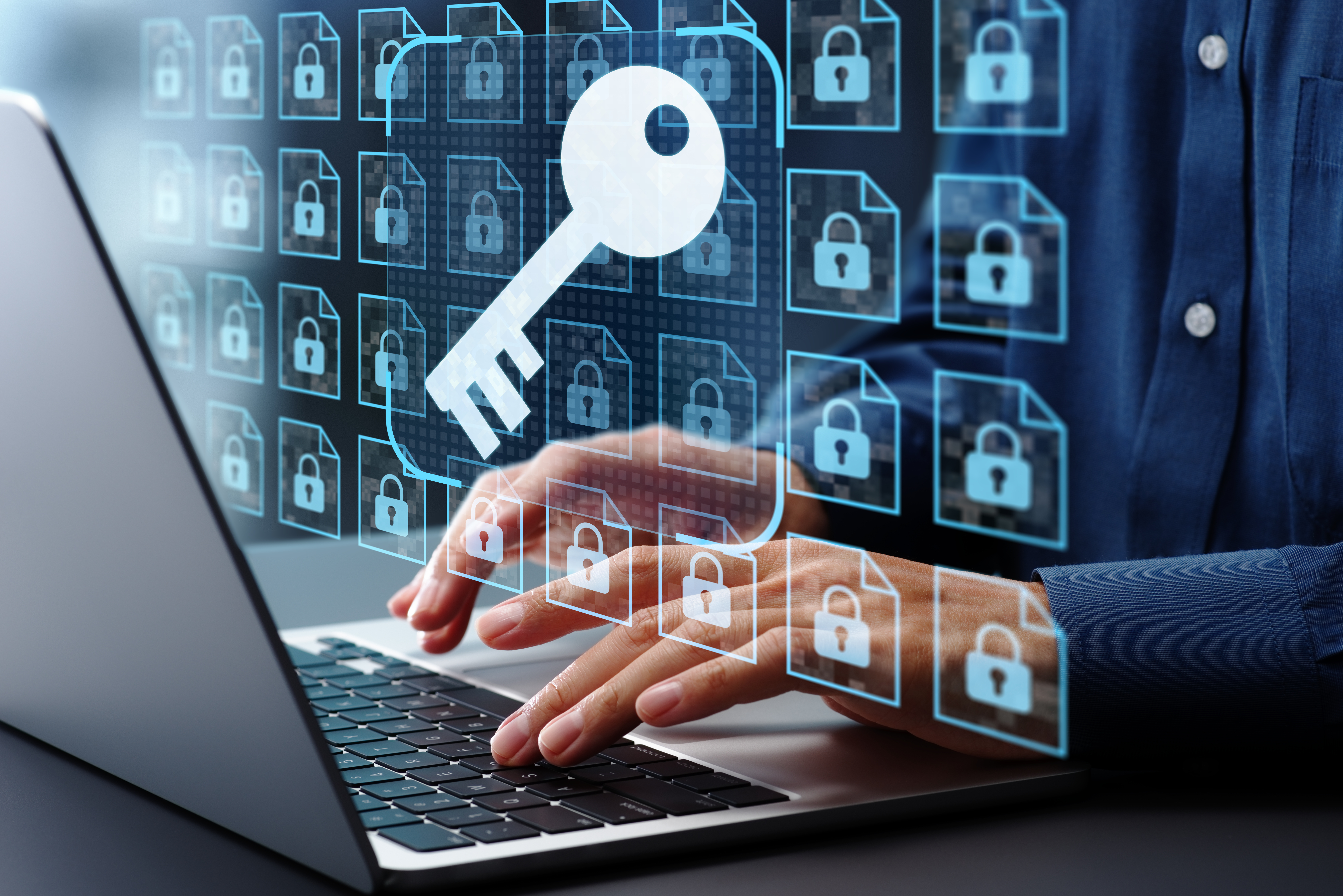 Businessman using laptop computer with an 
		emulated screen superimposed showing all files with a lock and a key poised over the whole thing.
